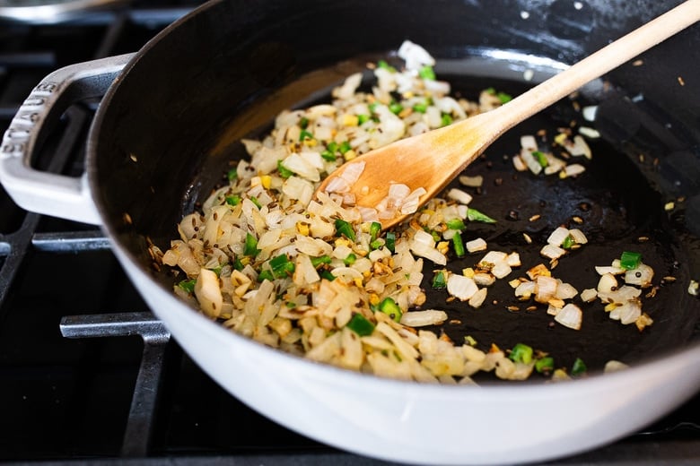 sautéing onion, garlic and ginger and green chilies in ghee