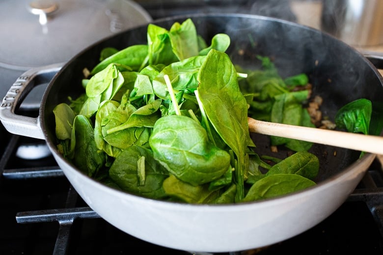 add spinach to the pan and wilt it