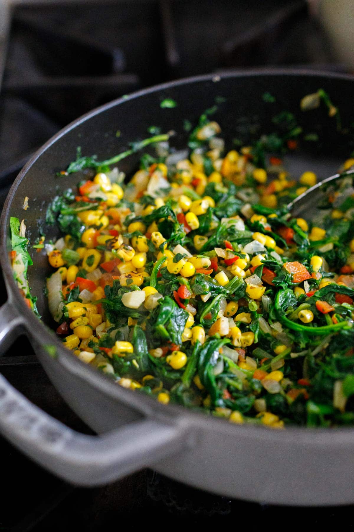 making the spinach filling on the stove . 