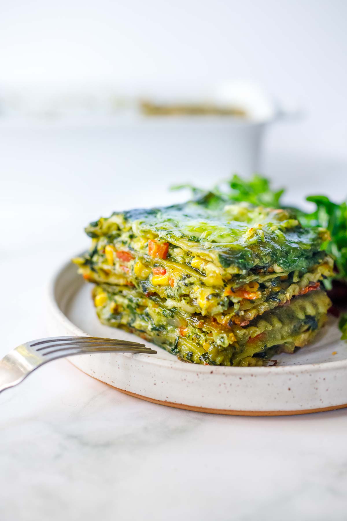 A delicious recipe for Spinach Lasagna filled with savory spinach and your choice of veggies and layered with a luscious Basil Spinach Sauce. Keep it vegetarian, or add chicken. 