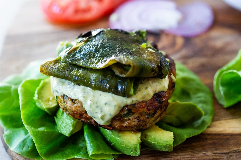 assembling a turkey burger in a lettuce wrap