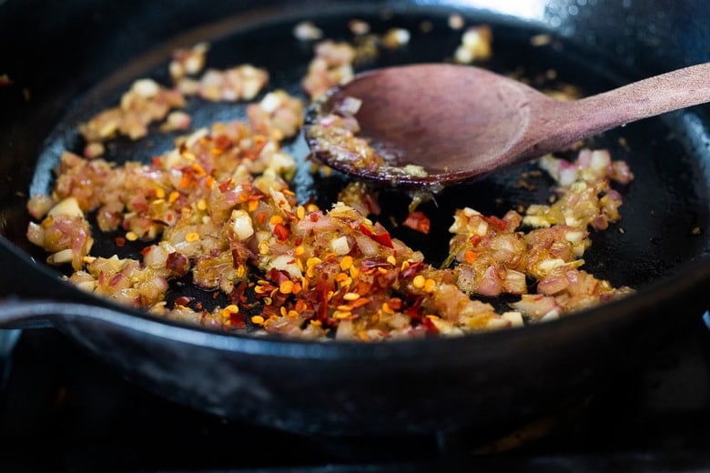 sautéing shallot garlic lemongrass giner in a skillet