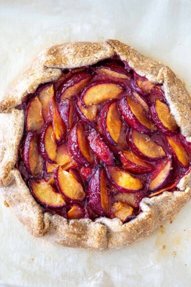 Juicy summer plums are highlighted in this simple recipe for Plum Galette with Buckwheat Crust. The buckwheat is super tasty - but optional here, so don't let it stop you! A pinch of five-spice adds a whisper of the exotic. #plumgalette #plumtart