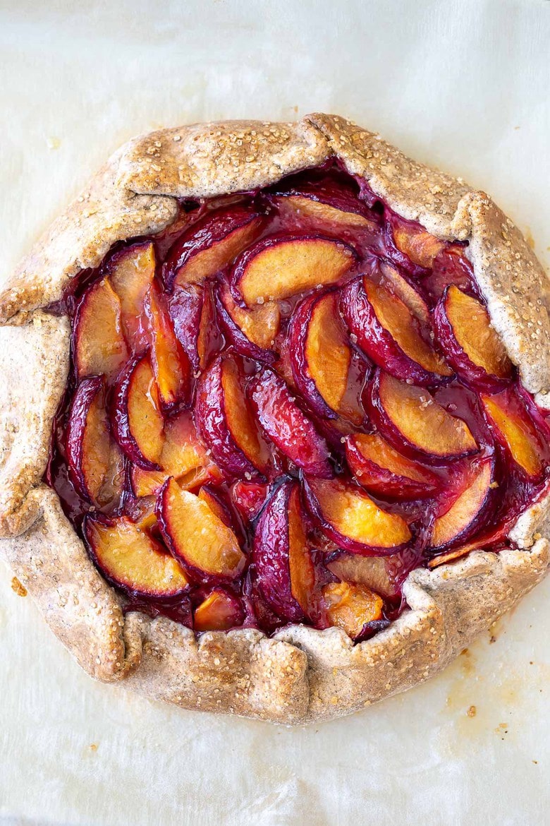 Juicy summer plums are highlighted in this simple recipe for Plum Galette with Buckwheat Crust. The buckwheat is super tasty - but optional here, so don't let it stop you! A pinch of five-spice adds a whisper of the exotic. #plumgalette #plumtart