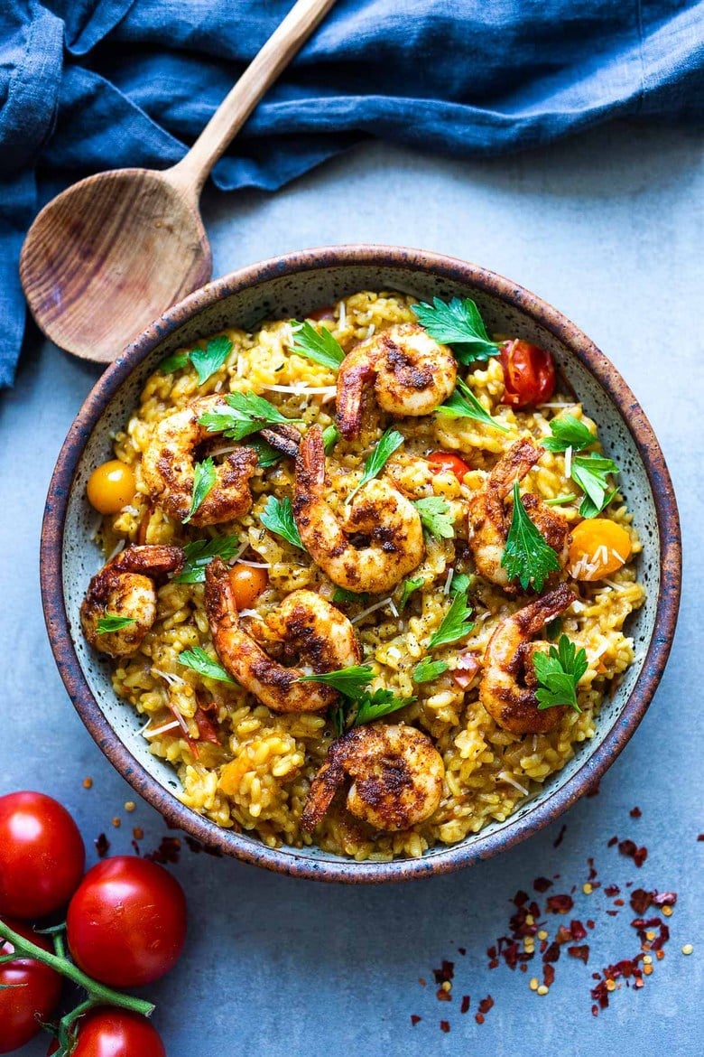 This summery risotto is made with juicy vine-ripened tomatoes, and saffron and can be kept vegetarian or topped off with smoky shrimp. #vegetarian #risotto #shrimprisotto 