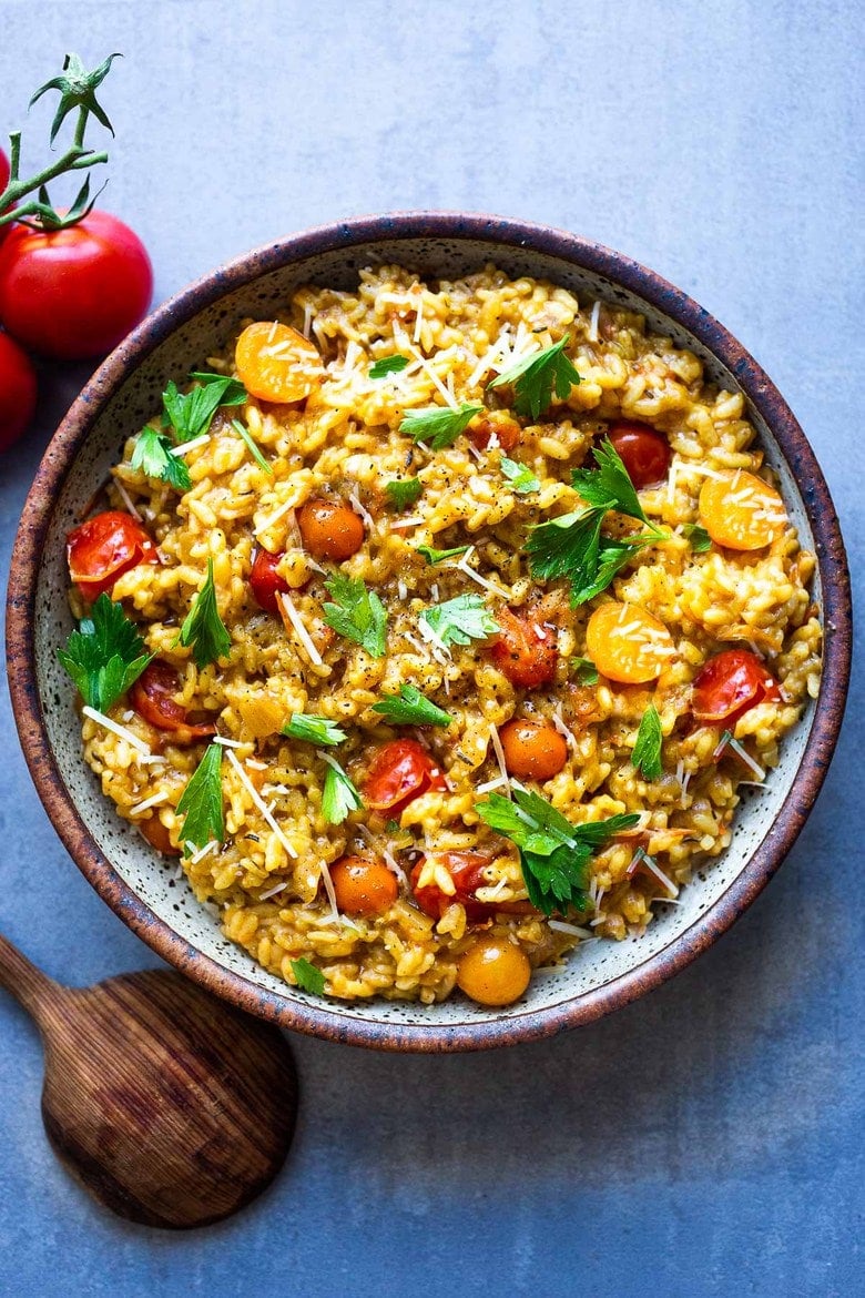 Summer Tomato Risotto with juicy vine-ripened tomatoes, and infused with saffron, can be served as a vegetarian main or sidedish, or topped off with smoky shrimp. #vegetarian #risotto #shrimprisotto 