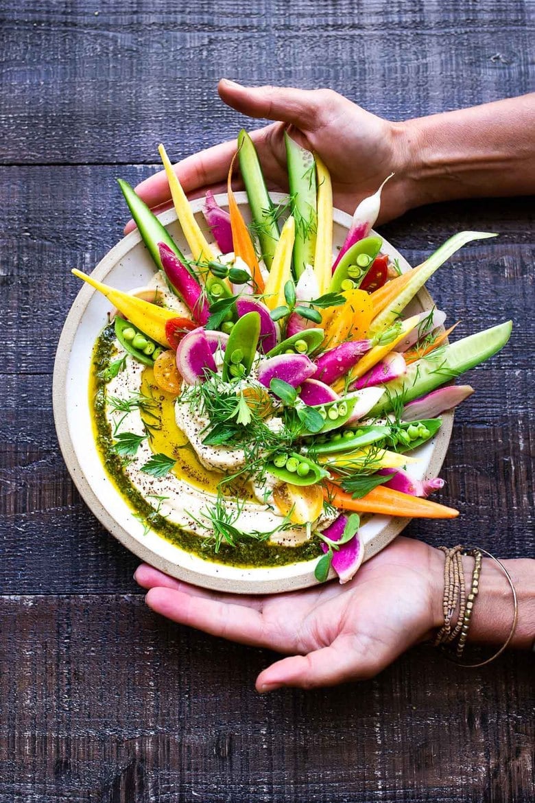 How to make Hummus! This authentic hummus recipe is light and creamy and so easy to make! Use canned or dried chickpeas and serve it up with fresh garden veggies! #hummus #hummusrecipe