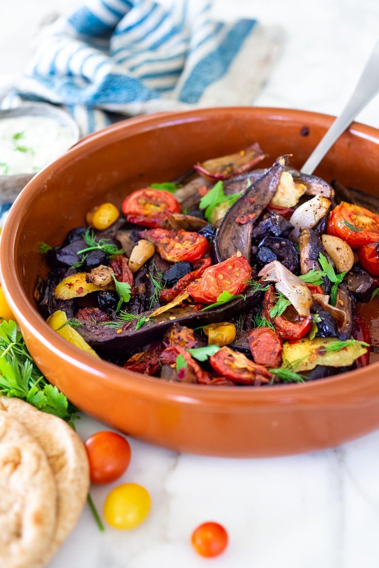 Slow-Baked Moroccan Eggplant with Ras el Hanout, caramelized garlic, shallots and tomatoes. A rustic side dish that can be turned into a hearty vegetarian main.  Serve with Basmati Rice or homemade Pita, and Tzatziki Sauce. #eggplant #veganrecipe #vegetariandinner