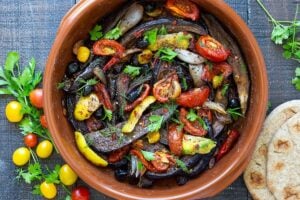 Slow-Baked Moroccan Eggplant with Ras el Hanout, caramelized garlic, shallots and tomatoes. A rustic side dish that can be turned into a hearty vegetarian main.  Serve with Basmati Rice or homemade Pita, and Tzatziki Sauce. #eggplant #vegetariandinner