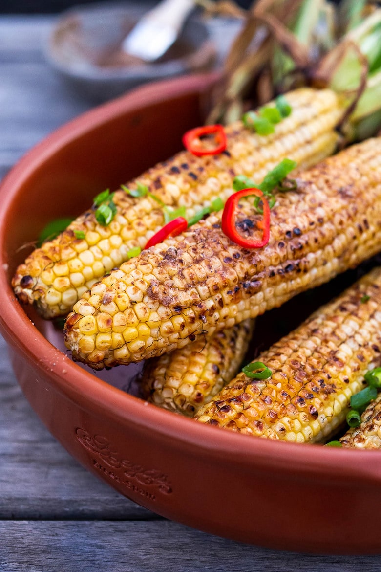 This Masala Street Corn hails from India and is grilled and seasoned with ghee and garam masala spice! A simple easy summer side dish to add to your next Indian feast! #grilledcorn #masalacorn #indiancorn