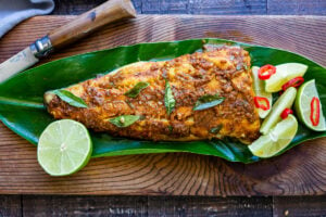 Here's a simple yet super flavorful recipe for Kerala-Style Fish, made with a flavorful paste that is either grilled or roasted in the oven. Curry leaves and Tamarind give this Indian Recipe its unique flavor. #kerala #keralafish #whitefish #indianrecipes