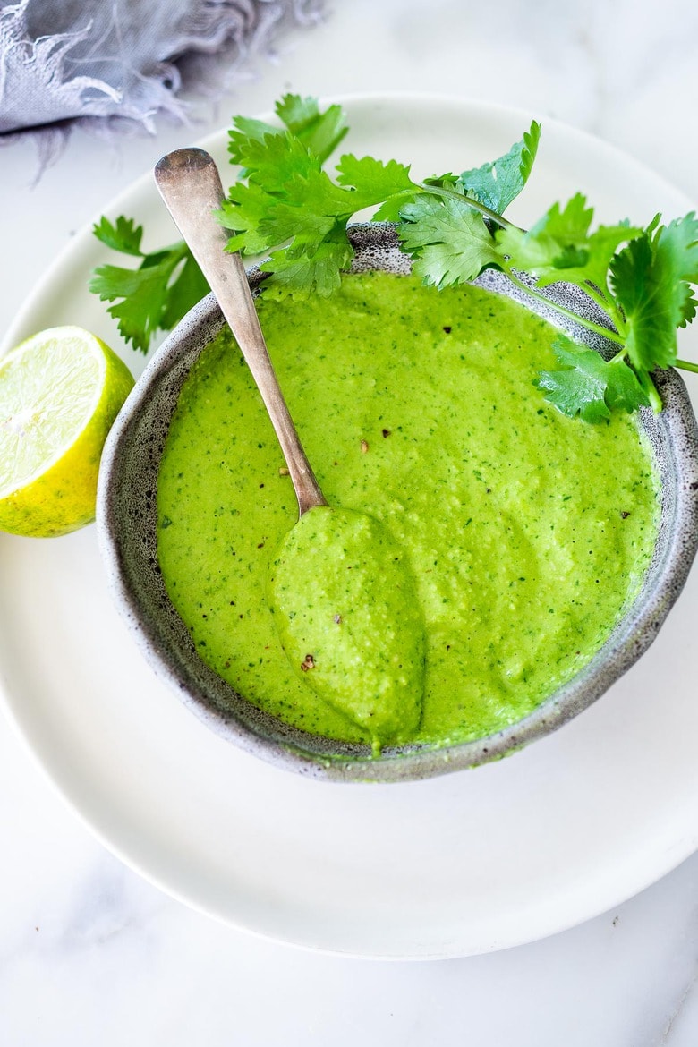 A delicious recipe for Peruvian Green Sauce (Aji Verde) made with fresh chilies, cilantro, garlic and lime. This version can be made with or without mayo, using cashews as the base (keeping it vegan & plant-based) if you like. Vegan-adaptable.