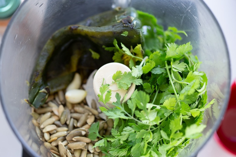 A flavorful recipe for Poblano Pumpkin Seed Sauce made with roasted poblano peppers and pumpkin seeds- a tasty addition to tacos, enchiladas, or burrito bowls! #poblanosalsa #pepitasalsa #pepitasauce