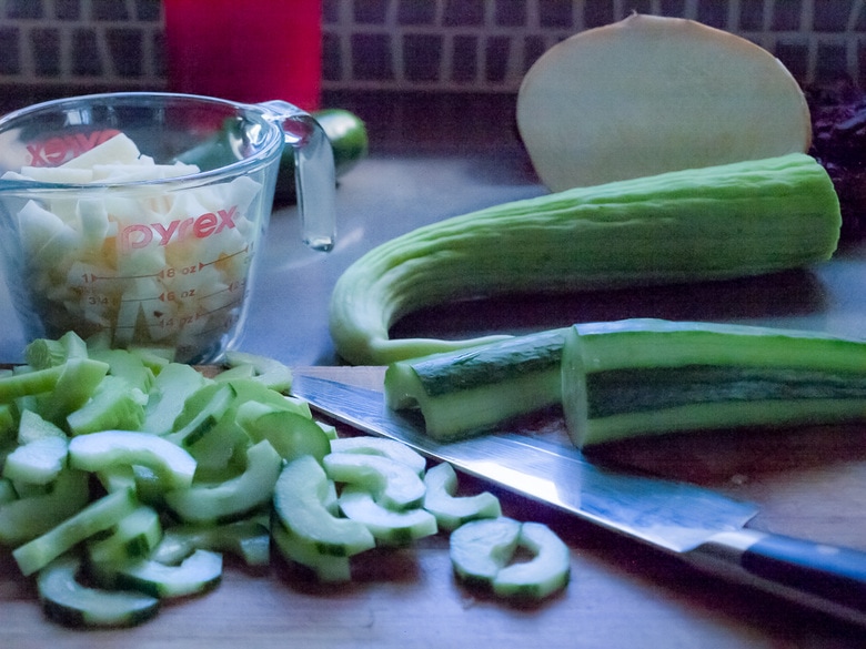 cucumber being chopped, plum salad recipe