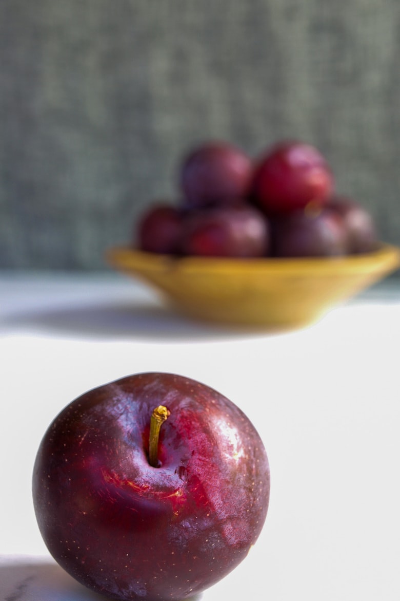 fresh plums in a bowl