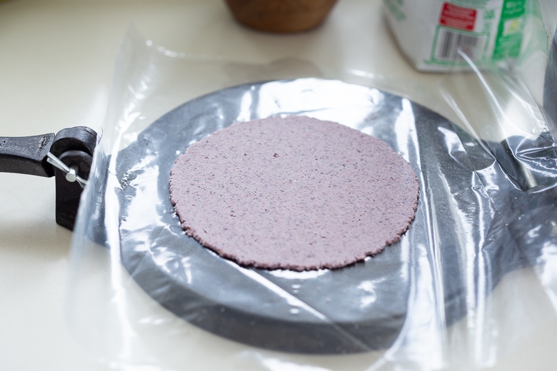 pressing dough into tortillas . 