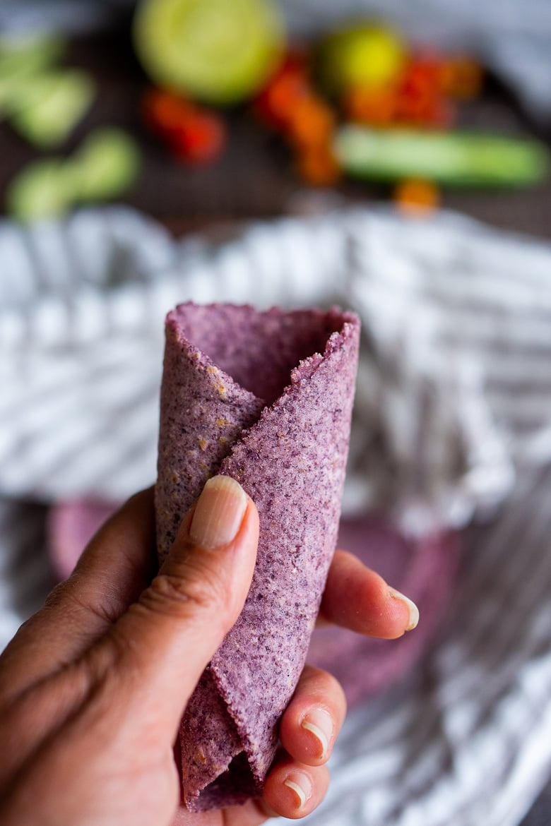 A blue corn tortilla rolled up in my hand. 