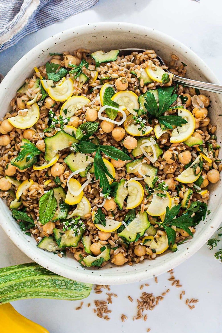 Mediterranean Farro Salad with Marinated Zucchini & Chickpeas, fresh herbs and optional feta, tossed a simple lemony dressing. #farrosalad #vegansalad #zucchinirecipes #chickpeasalad