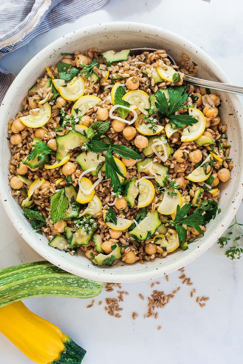 Mediterranean Farro Salad with Marinated Zucchini & Chickpeas, fresh herbs and optional feta, tossed a simple lemony dressing. #farrosalad #vegansalad #zucchinirecipes #chickpeasalad