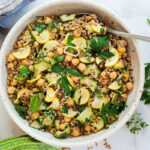 Mediterranean Farro Salad with Marinated Zucchini & Chickpeas, fresh herbs and optional feta, tossed a simple lemony dressing. #farrosalad #vegansalad #zucchinirecipes #chickpeasalad