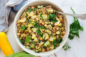 Mediterranean Farro Salad with Marinated Zucchini & Chickpeas, fresh herbs and optional feta, tossed a simple lemony dressing. #farrosalad #vegansalad #zucchinirecipes #chickpeasalad