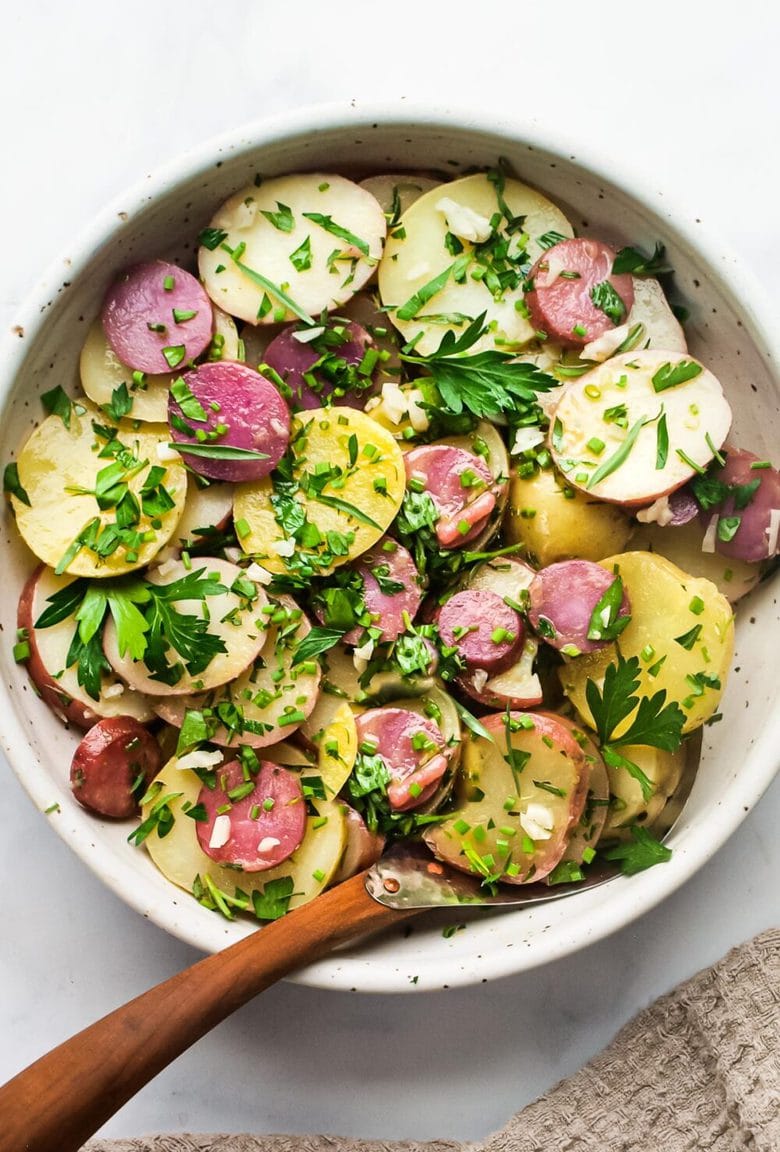 A simple French Potato Salad with fresh herbs - tarragon, parsley and chives, with a flavorful Dijon Vinaigrette. Healthy, vegan and light with no mayo!  