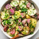 A simple French Potato Salad with fresh herbs - tarragon, parsley and chives, with a flavorful Dijon Vinaigrette. Healthy, vegan and light with no mayo!