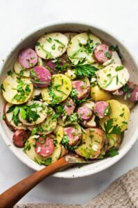 A simple French Potato Salad with fresh herbs - tarragon, parsley and chives, with a flavorful Dijon Vinaigrette. Healthy, vegan and light with no mayo!  