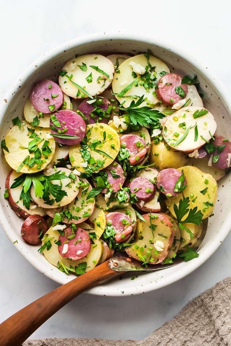 35+ Best Potluck Ideas | A simple French Potato Salad with fresh herbs - tarragon, parsley and chives, with a flavorful Dijon Vinaigrette. Healthy, vegan and light with no mayo!  This salad is so easy to make, so flavorful and so perfect for sharing!  Take it to the potluck, your friends will thank you!