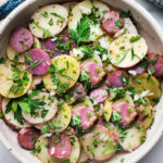 This French Potato Salad is loaded up with fresh herbs - tarragon, parsley and chives and dressed in the most flavorful dijon vinaigrette. It's vegan, with no mayo, and easy. to make! #herbedpotatosalad #frenchpotatosalad #veganpotatosalad