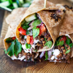 Turkish Lamb Wrap with ground lamb, sumac, mint, cucumbers, tomatoes and yogurt.
