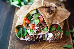 Turkish Lamb Wrap with ground lamb, sumac, mint, cucumbers, tomatoes and yogurt.