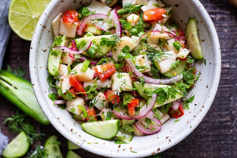 This vegan, plant-based Ceviche will transport you to Mexico. Made with hearts of palm and avocado, this easy recipe can be served on tostadas, with chips or in lettuce cups! #veganceviche #heartsofpalm #veganmexican #ceviche