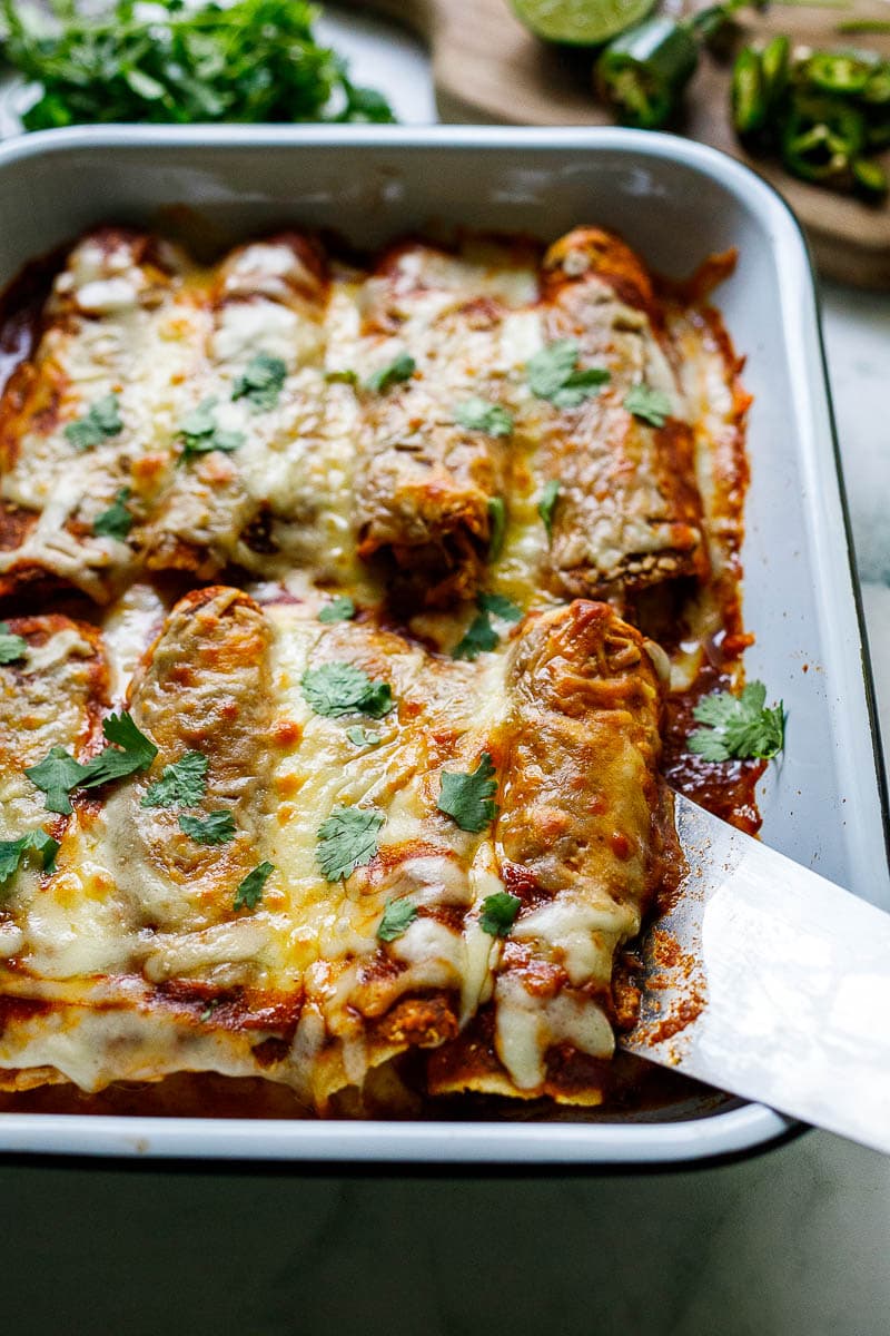 Easy Chicken Enchiladas made with the simplest of ingredients.  With just a few minutes of assembly time, bake it for 20 minutes, and dinner is ready. Everyone is happy! 