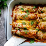 Easy Chicken Enchiladas made with the simplest of ingredients.  With just a few minutes of assembly time, bake it for 20 minutes, and dinner is ready. Everyone is happy! 