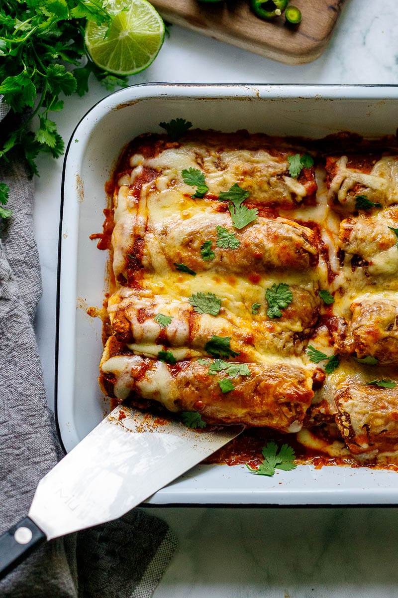 Easy Chicken Enchiladas made with the simplest of ingredients. With just a few minutes of assembly time, bake it for 20 minutes, and dinner is ready. Everyone is happy!