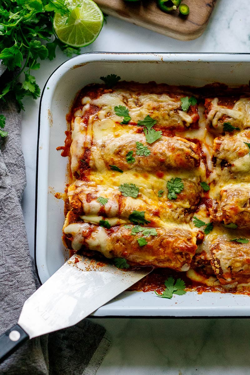 Easy Chicken Enchiladas made with the simplest of ingredients.  With just a few minutes of assembly time, bake it for 20 minutes, and dinner is ready. Everyone is happy! 