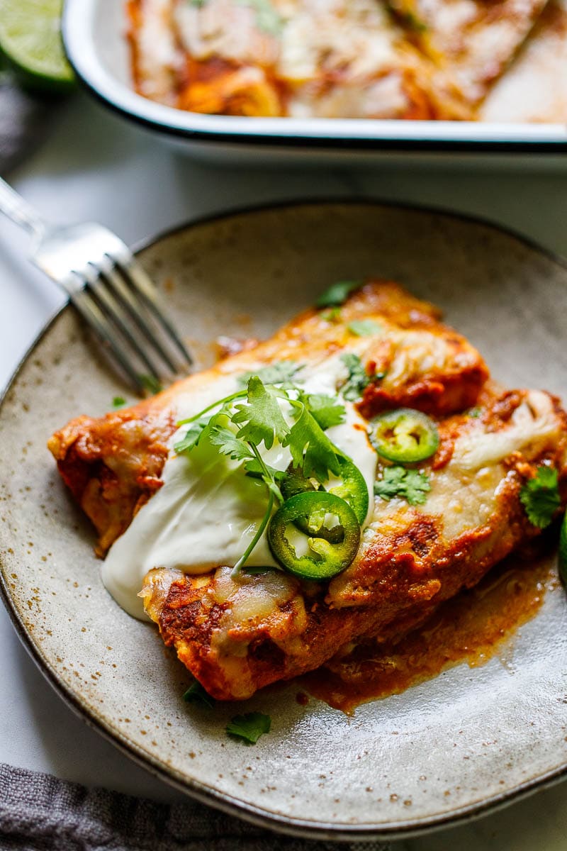 Easy Chicken Enchiladas made with the simplest of ingredients.  With just a few minutes of assembly time, bake it for 20 minutes, and dinner is ready. Everyone is happy! 