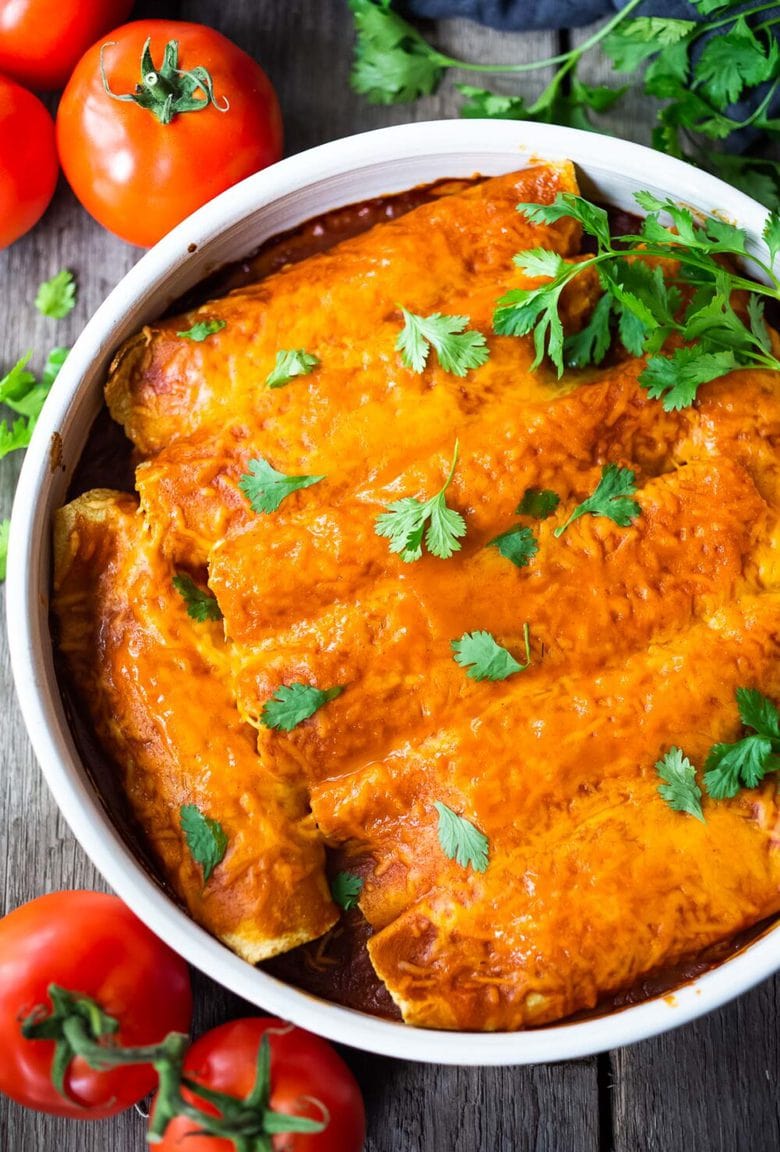 Chicken Enchiladas made with 5-Minute Enchilada Sauce (easy red sauce) and shredded chicken. A delicious comfort food meal the whole family will love. #enchiladas #chickenenchiladas