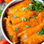 Chicken Enchiladas made with 5-Minute Enchilada Sauce (easy red sauce) and shredded chicken. A delicious comfort food meal the whole family will love. #enchiladas #chickenenchiladas