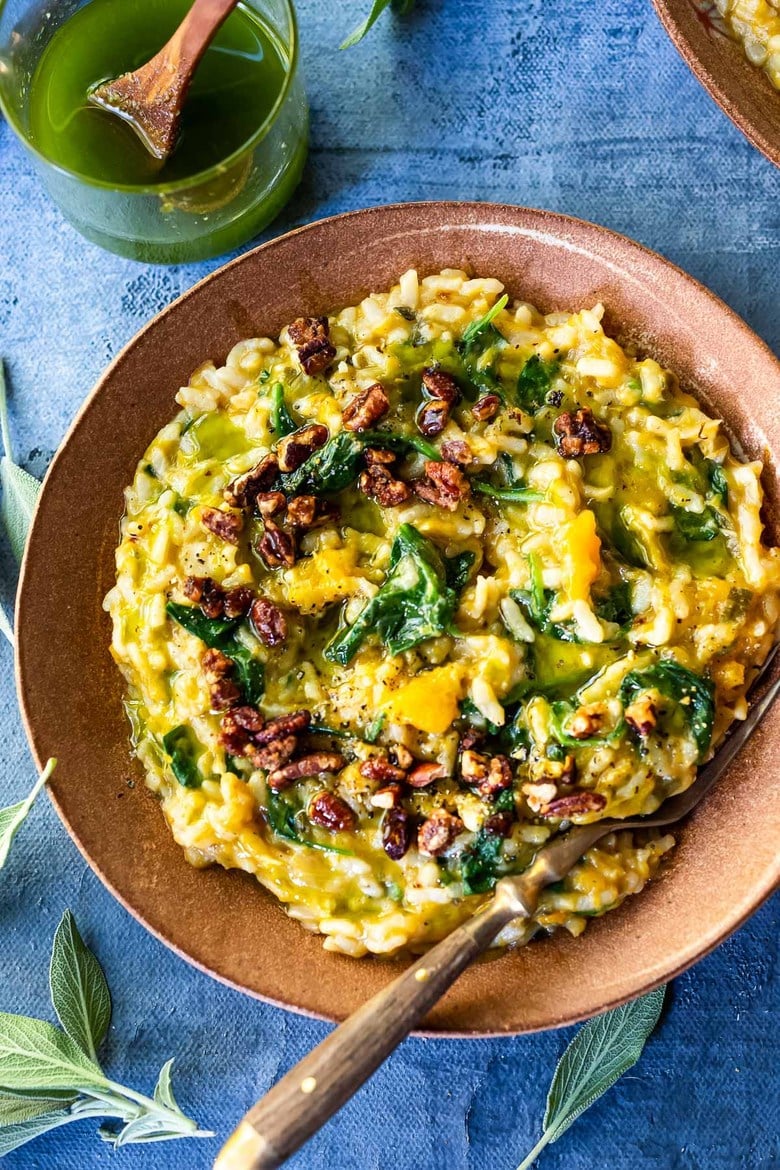 Butternut squash risotto in a bowl with a fork. 