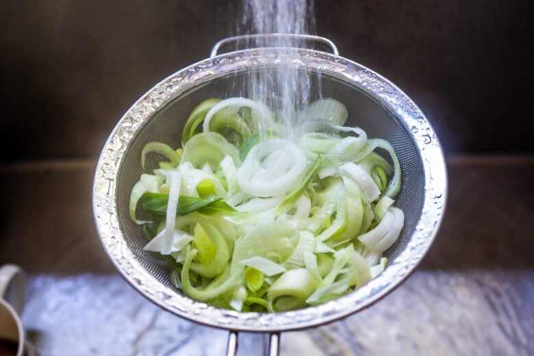 Leeks in colander.