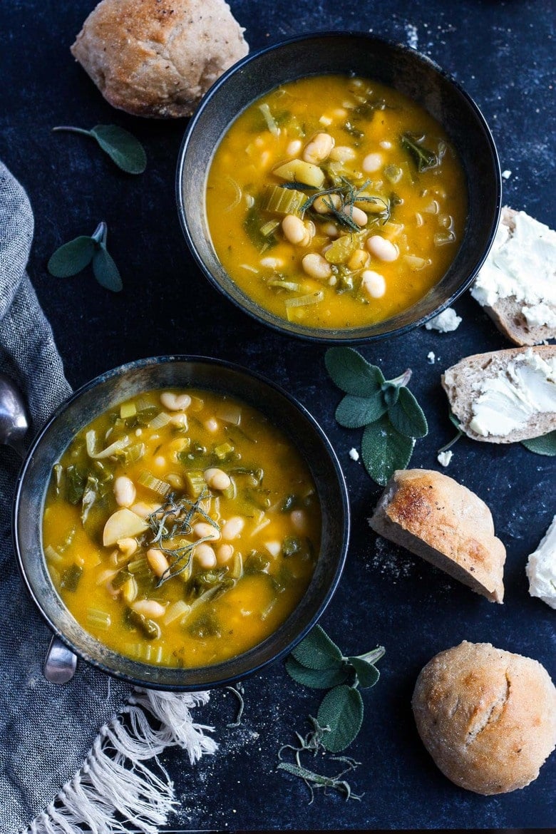 A simple recipe for Pumpkin Soup With Leeks, Kale, white beans and Sage. Vegan, flavorful, and EASY- can be made in 30 minutes! #pumkinsoup #vegansoup