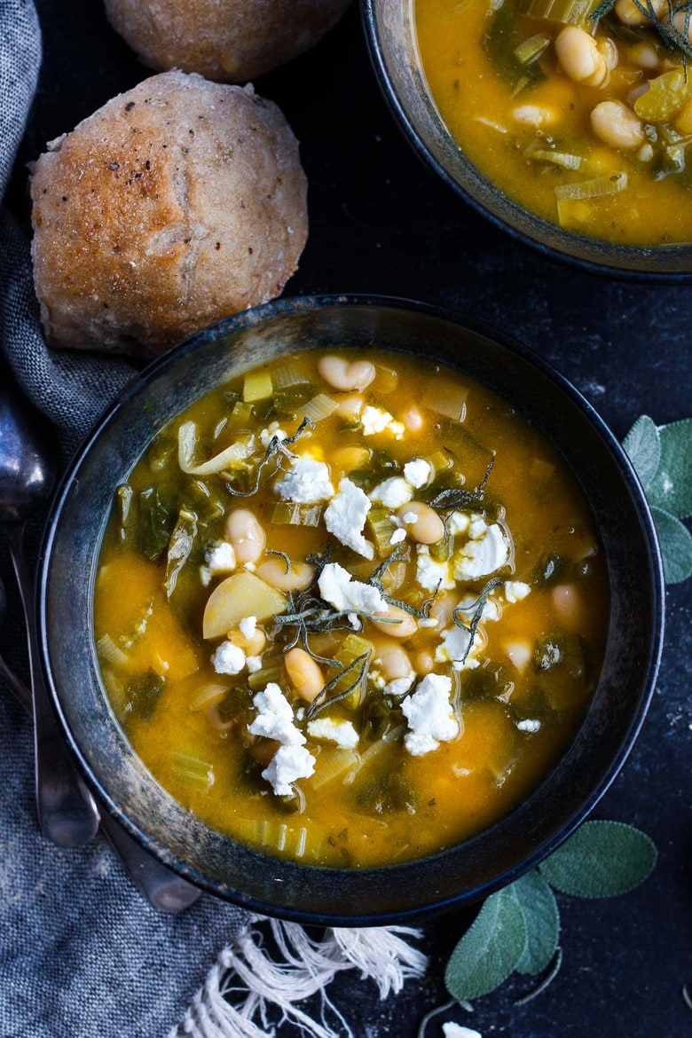 A simple recipe for Pumpkin Soup With Leeks, Kale, white beans and Sage. Vegan, flavorful, and EASY- can be made in 30 minutes! #pumkinsoup #vegansoup