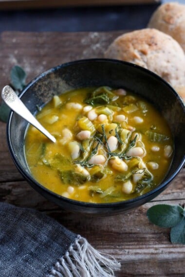 A simple recipe for Pumpkin Soup With Leeks, Kale, white beans and Sage. Vegan, flavorful, and EASY- can be made in 30 minutes! #pumkinsoup #vegansoup