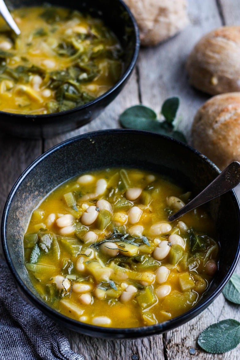 A simple recipe for Pumpkin Soup With Leeks, Kale, white beans and Sage. Vegan, flavorful, and EASY- can be made in 30 minutes! #pumkinsoup #vegansoup