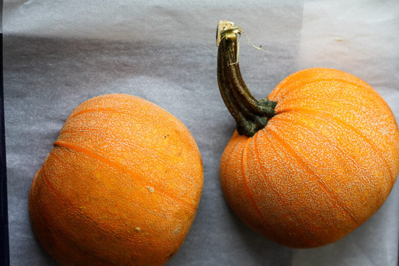 Pumpkins halves on a pan.