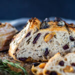 How to make Crusty Sourdough Bread, infused with rosemary, roasted garlic and olives that requires no kneading and rises overnight. Made with sourdough starter instead of yeast! #sourdoughbread