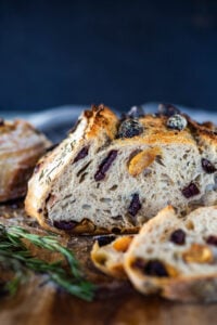 How to make Crusty Sourdough Bread, infused with rosemary, roasted garlic and olives that requires no kneading and rises overnight. Made with sourdough starter instead of yeast! #sourdoughbread