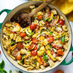 A simple recipe for Tomato Zucchini Gratin with breadcrumbs, parmesan and fresh basil. A quick and easy vegetarian side dish! #gratin #tomatogratin #zucchinigratin